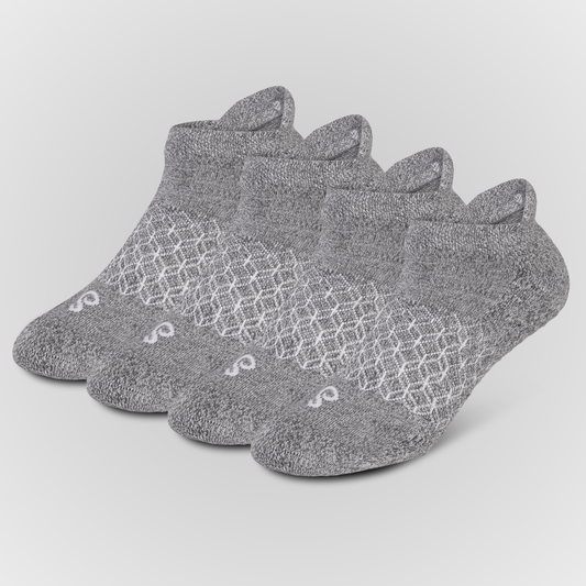 Four grey hipSwan low-cut ankle grip socks arranged in a fan shape on a light gray background. The socks feature a textured knit pattern with a white geometric lattice design across the instep and a small white logo near the toe.