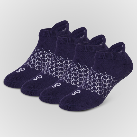 Four pairs of navy blue hipSwan Flow Ankle low-cut grip socks with a white geometric honeycomb pattern and a small white logo on the toe, arranged in a fan shape on a light gray background.