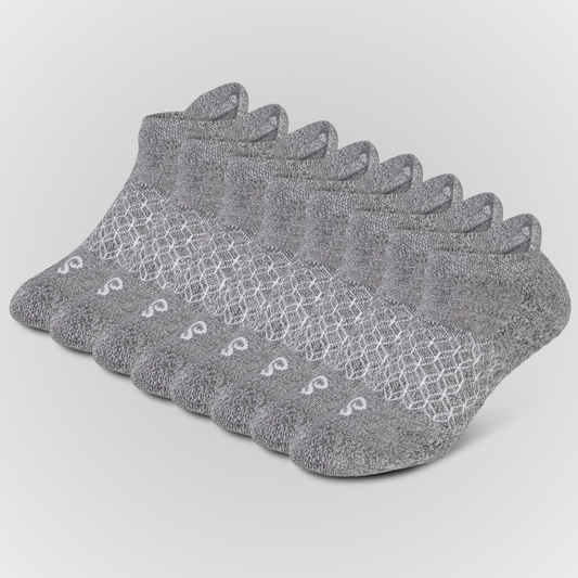 Eight grey hipSwan Flow Ankle low-cut ankle grip socks arranged in a fan shape on a light gray background. The socks feature a textured knit pattern with a white geometric lattice design across the instep and a small white logo near the toe.