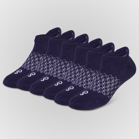 Six pairs of hipSwan Flow Ankle grip socks. Low-cut ankle socks in dark navy blue, arranged in a fan shape. Each pair features a white geometric honeycomb pattern across the midfoot and a small white stylized 'S' logo on the toe.