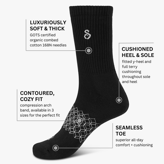 Black organic cotton cushioned crew sock with text highlighting features on a white background